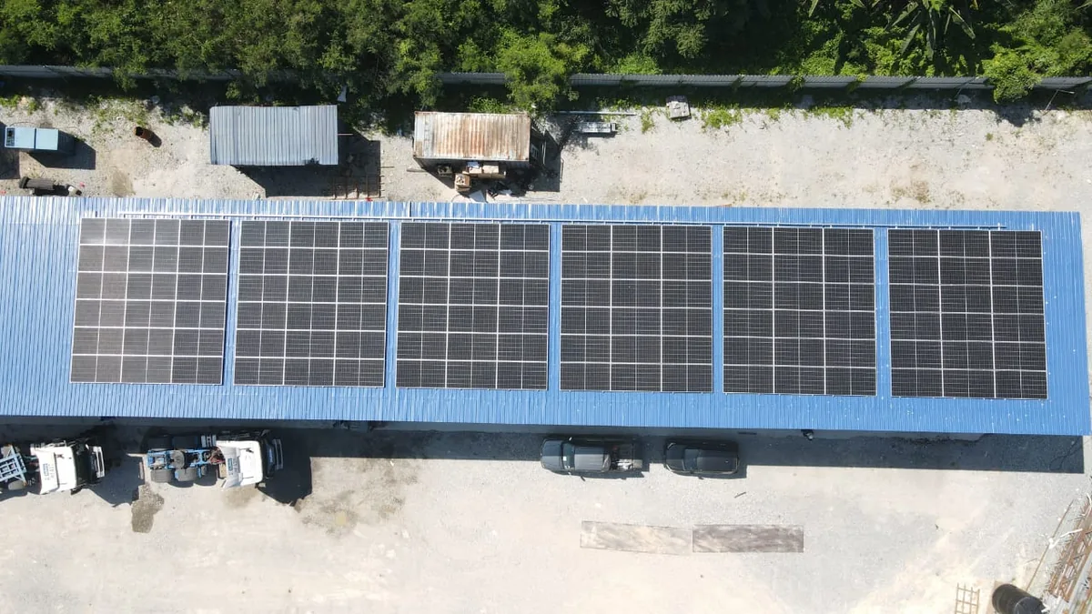 Logistics warehouse with rooftop solar panels and battery storage units in Klang
