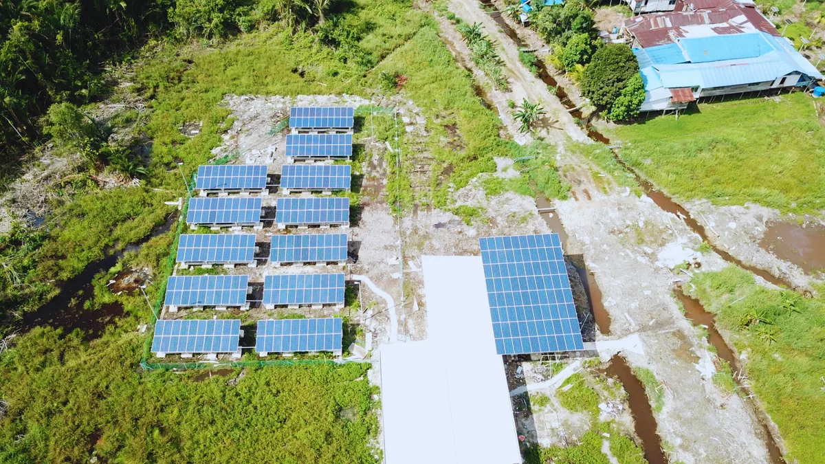 Solar panels powering a water treatment facility in rural Sarawak
